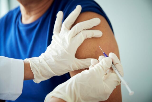 doctor giving injection in arm